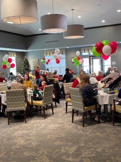 People are in the dining hall celebrating breakfast with Santa