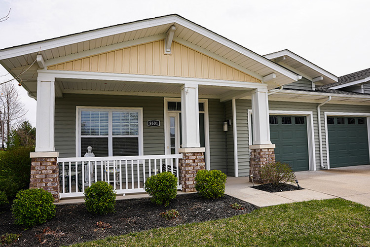 External living community space with green paneling and gray roofs. Garden included